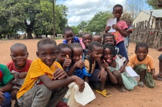 Djeca zajedno vani ispred škole u Mozambiku.